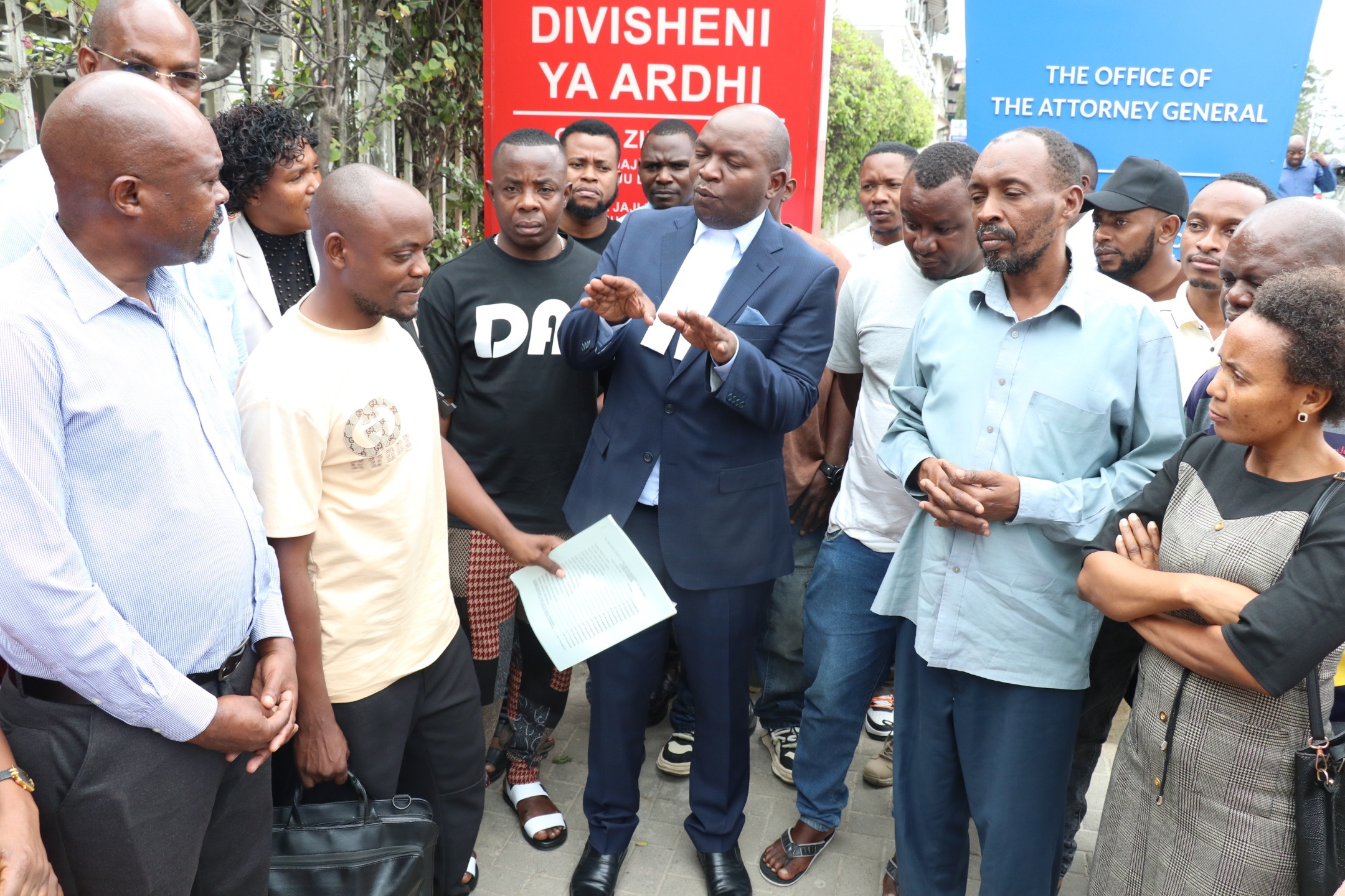  People affected by the collapse of a building in DSM’s Kariakoo market zone listen their lawyer Peter Madeleka  at the Land Division of the High Court of Tanzania yesterday after the hearing a case they have filed, seeking a total of 40bn/- compensation.