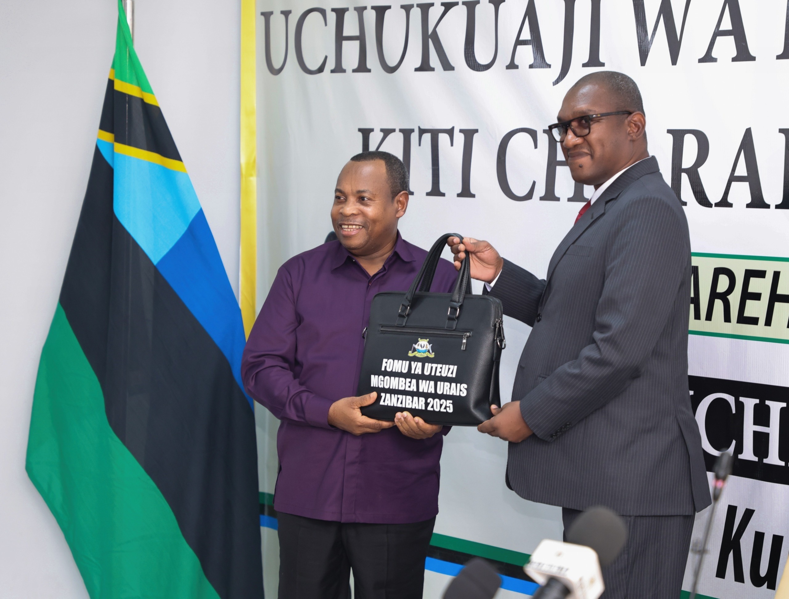 ZEC Chairman Judge George Joseph Kazi pictured at the commission’s offices at Maisara in Unguja Urban District yesterday presenting nomination form to Othman Masoud Othman, the opposition ACT-Wazalendo candidate for the Zanzibar Presidency